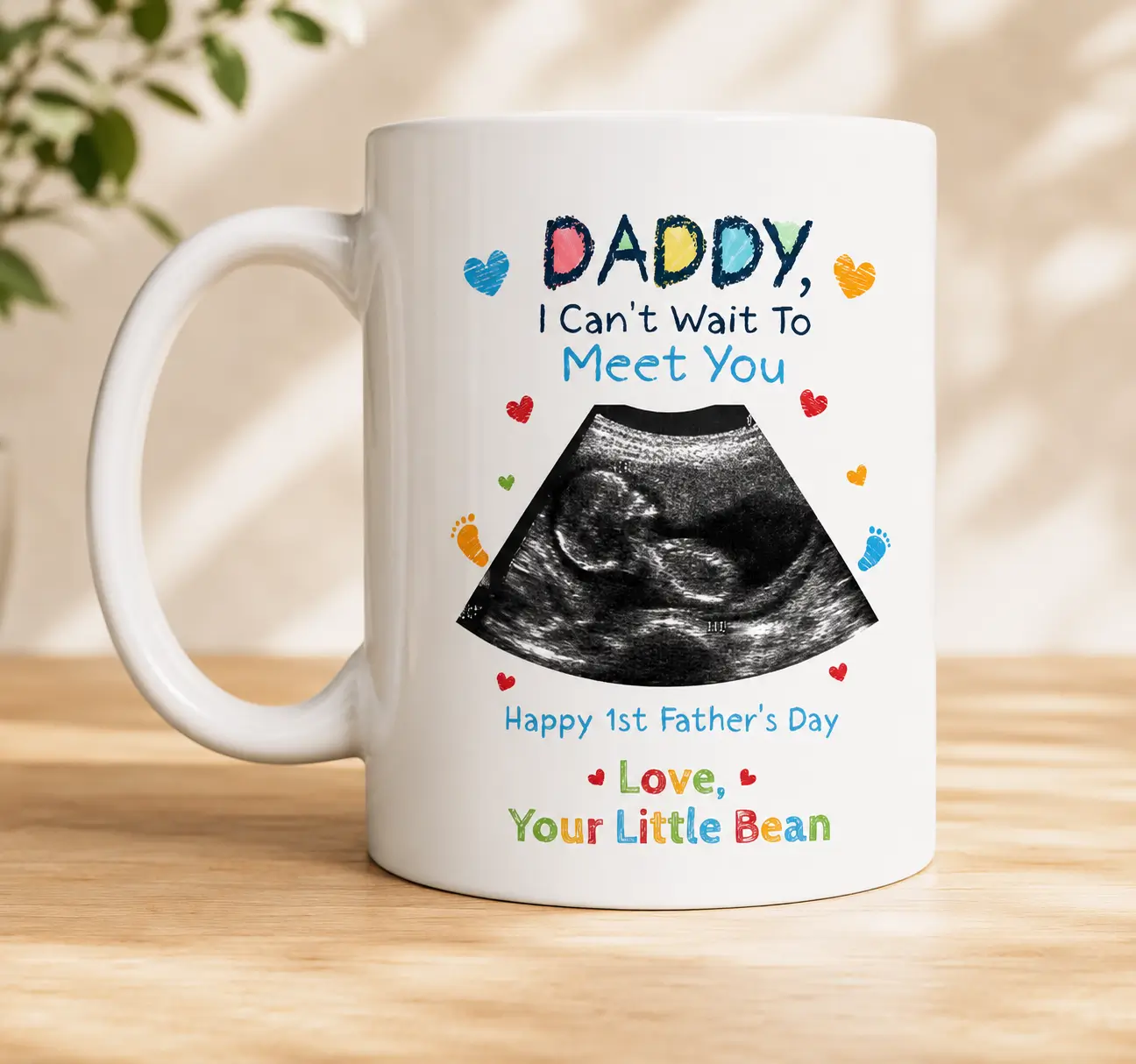 White ceramic Father's Day mug featuring a baby ultrasound photo with the colorful message "Daddy, I Can't Wait To Meet You" presented in a kraft gift box with ribbon, making a thoughtful pregnancy announcement and first Father's Day gift.