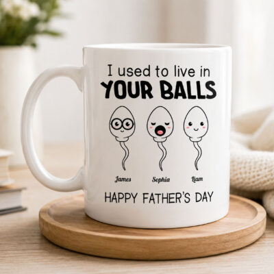 Lifestyle mockup of a personalized Father's Day coffee mug featuring the funny quote "I Used to Live in Your Balls" with custom children's names and customizable number of child illustrations.