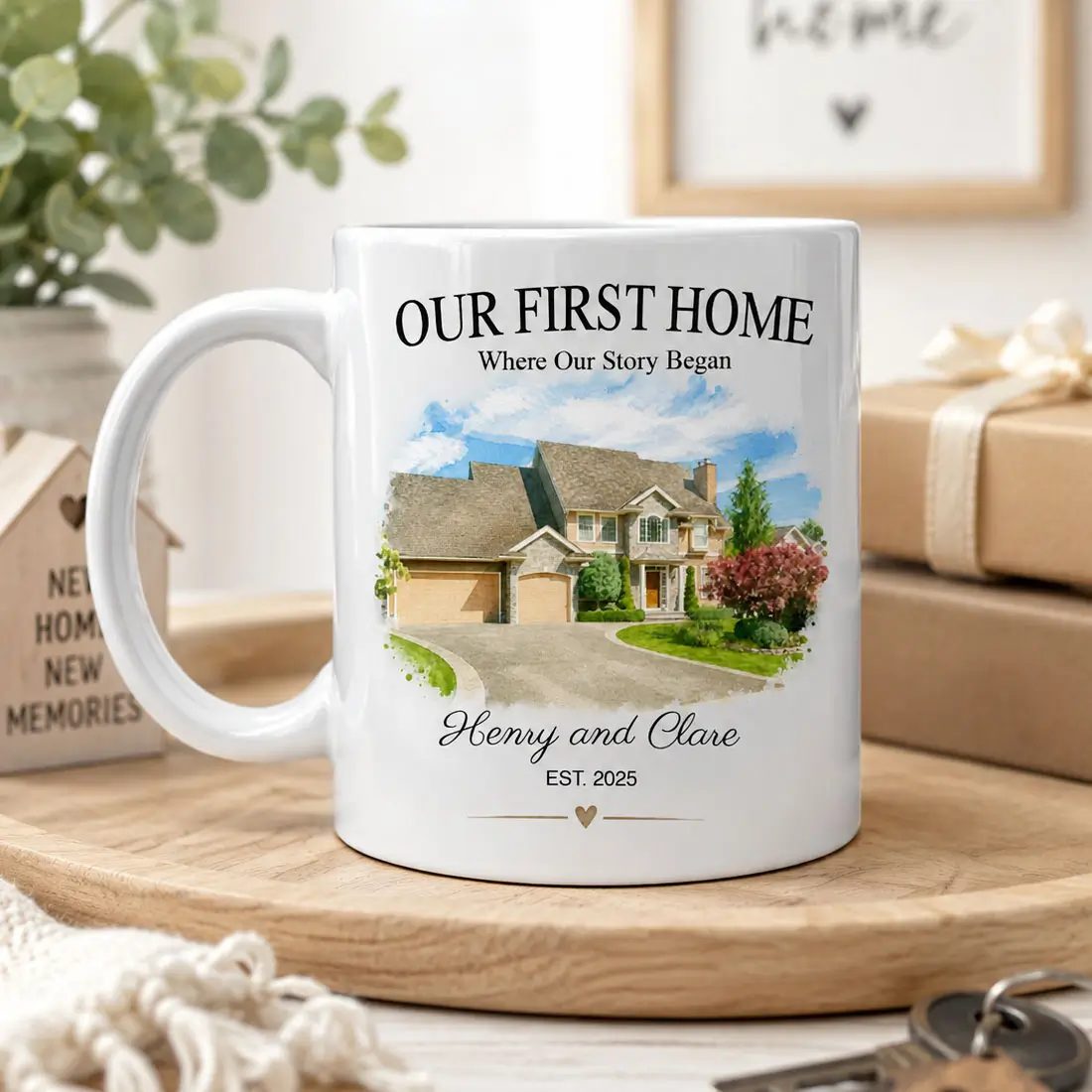 Personalized first home photo mug displayed with housewarming gifts, custom watercolor home portrait and couple names